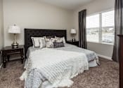 Thumbnail 18 of 50 - a bedroom with a bed and a window at Stonegate Crossing Apartments, IOWA, 50325