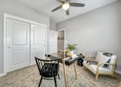 Thumbnail 12 of 57 - an office with a desk and a ceiling fan at Rialto Townhomes Apartments, Waukee, 50263