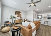Thumbnail 4 of 57 - a living room with a couch and a ceiling fan at Rialto Townhomes Apartments, Waukee, 50263