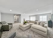 Thumbnail 17 of 57 - a living room with a couch and a chair at Rialto Townhomes Apartments, Iowa