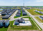 Thumbnail 57 of 57 - an aerial view of a neighborhood of houses in a field at Rialto Townhomes Apartments, Waukee, IA, 50263