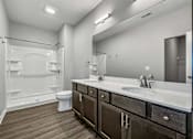 Thumbnail 30 of 57 - a bathroom with a sink and a toilet and a shower at Rialto Townhomes Apartments, Iowa