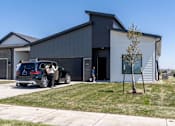 Thumbnail 56 of 57 - a car is parked in front of a building at Rialto Townhomes Apartments, Waukee, Iowa