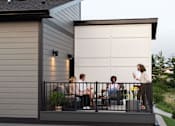 Thumbnail 19 of 57 - a group of people sitting on a balcony at Rialto Townhomes Apartments, Waukee, IA