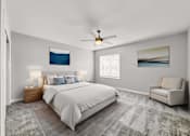 Thumbnail 18 of 57 - a bedroom with a bed and a ceiling fan at Rialto Townhomes Apartments, Waukee, Iowa