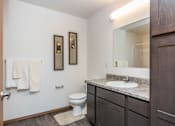 Thumbnail 24 of 33 - a bathroom with a toilet and a sink and a mirror at Penbrooke Place Apartments, Sioux Falls, 57106