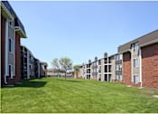 Thumbnail 33 of 33 - an exterior view of an apartment complex with green grass at Penbrooke Place Apartments, Sioux Falls, SD, 57106
