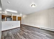 Thumbnail 14 of 33 - A room with wooden flooring and a white wall at Penbrooke Place Apartments, Sioux Falls, SD, 57106