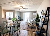Thumbnail 15 of 33 - A living room with a glass table and chairs at Penbrooke Place Apartments, Sioux Falls, SD