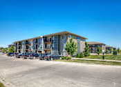 Thumbnail 22 of 35 - A large building with a parking lot in front of it.
