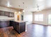 Thumbnail 1 of 35 - A kitchen with dark wood cabinets and a light colored floor.