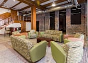 Thumbnail 7 of 13 - A room with a staircase and a couch.at Riverpoint Lofts, Des Moines, 50309  