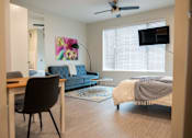 Thumbnail 4 of 27 - a bedroom and living room with a couch and a bed at Canary Lofts, Iowa, 50311