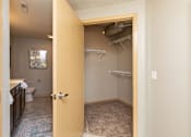 Thumbnail 11 of 31 - an open bathroom door looking into a bathroom with a shower and a toilet at Lake Shore Apartments, Ankeny