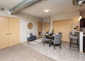 Thumbnail 10 of 31 - a dining room and living room with a table and chairs at Lake Shore Apartments, Iowa