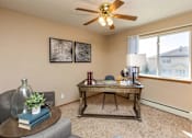 Thumbnail 5 of 22 - A room with a table, chairs, and a ceiling fan at Lake Shore Park, Ankeny, IA 50021