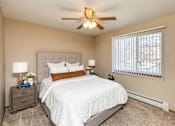 Thumbnail 2 of 22 - a bedroom with a bed and a ceiling fan at Lake Shore Park, Ankeny