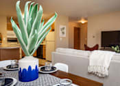 Thumbnail 12 of 22 - a living room with a couch and a table with a plant at Lake Shore Park, Ankeny, IA 50021