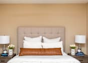 Thumbnail 16 of 22 - a bedroom with a bed and two nightstands with lamps at Lake Shore Park, Ankeny
