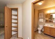 Thumbnail 6 of 22 - A bathroom with a toilet, sink, and mirror at Lake Shore Park, Ankeny, IA