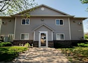 Thumbnail 9 of 10 - a white house with a sidewalk in front of it at Peach Tree Apartments, Ankeny