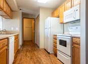 Thumbnail 2 of 12 - a kitchen with wood flooring and white appliances at Sunrise Meadows, Waukee
