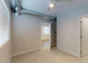 Thumbnail 15 of 31 - an empty room with a closet and a ceiling fan at Vue Apartments, Des Moines, Iowa