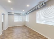Thumbnail 13 of 31 - a living room with a hard wood floor and a large window at Vue Apartments, Des Moines, IA