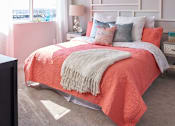 Thumbnail 8 of 31 - a bedroom with a bed and pillows and a window at Vue Apartments, IA, 50309