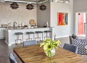 Thumbnail 23 of 31 - a dining room with tables and chairs and potted plants at Vue Apartments, Iowa, 50309