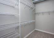 Thumbnail 9 of 31 - spacious closet with shelves and racks at theria apartments at Vue Apartments, Des Moines