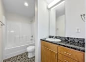 Thumbnail 6 of 50 - A bathroom with a toilet, sink, and shower at The Des Moines Building Apartments, IA, 50309