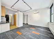 Thumbnail 31 of 50 - A room with a grey carpet and a white wall at The Des Moines Building Apartments, Iowa, 50309