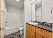 Thumbnail 29 of 50 - A bathroom with a white toilet, a white sink, and a white bathtub at The Des Moines Building Apartments, Des Moines, Iowa