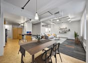 Thumbnail 3 of 50 - A modern kitchen with a dining table and chairs at The Des Moines Building Apartments, Des Moines, IA, 50309