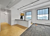Thumbnail 19 of 50 - A room with a desk and a window overlooking a cityscape at The Des Moines Building Apartments, Iowa, 50309