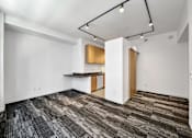 Thumbnail 25 of 50 - A room with a carpeted floor and a kitchenette at The Des Moines Building Apartments, IA, 50309