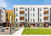 Thumbnail 6 of 26 - a building with a lawn in front of it at Rowat Lofts, Des Moines, IA  