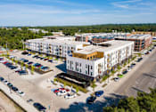 Thumbnail 23 of 26 - an aerial view of an apartment complex and parking lot at Rowat Lofts, Des Moines  