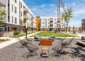 Thumbnail 25 of 26 - a courtyard with a table and chairs in front of an apartment building at Rowat Lofts, Iowa   