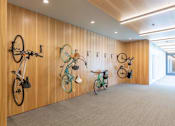 Thumbnail 8 of 26 - three bikes hanging on a wall in a room at Rowat Lofts, Des Moines, IA 50309  