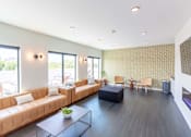 Thumbnail 11 of 26 - a living room with leather couches and a table at Rowat Lofts, Des Moines, 50309  