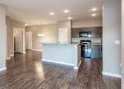 Thumbnail 3 of 32 - a renovated kitchen and living room with wood flooring at The Barclay Apartments, Altoona, IA