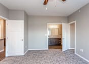 Thumbnail 11 of 32 - a bedroom with a carpeted floor and a door to a bathroom at The Barclay Apartments, Altoona, 50009