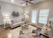 Thumbnail 9 of 32 - a living room with a couch and a ceiling fan at The Barclay Apartments, Altoona, IA
