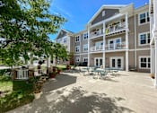 Thumbnail 19 of 22 - A sunny day at the outdoor patio of a multi-story apartment building.at Cornerstone Commons, Johnston, 50131  