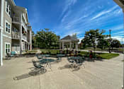 Thumbnail 15 of 22 - A sunny day at the outdoor seating area of a residential building.at Cornerstone Commons, Johnston, IA  