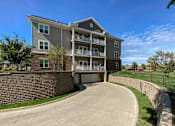 Thumbnail 20 of 22 - A large apartment building with a driveway in front.at Cornerstone Commons, Iowa, 50131