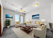 Thumbnail 2 of 22 - A living room with a white couch, a coffee table, and a ceiling fan.at Cornerstone Commons, Johnston, IA  