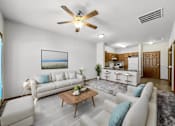 Thumbnail 1 of 22 - A living room with a white couch, a coffee table, and a ceiling fan.at Cornerstone Commons, Johnston, IA 50131  